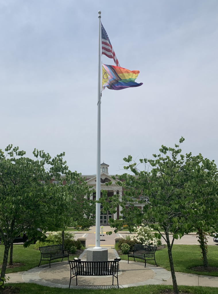 American flag and LGBTQ+ pride flag at natick high school