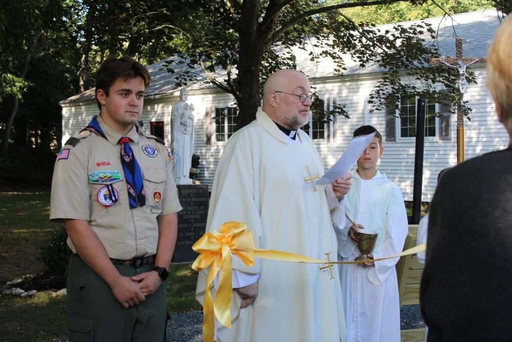 Rev. George C. “Chip” Hines, pastor of the Natick Catholic Community, recites a prayer during adedication ceremony for the new prayer garden at St. Linus Church on Sunday, Sept. 21.