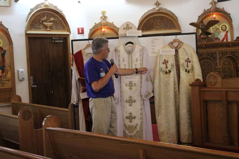 A member of St. Mark’s Coptic Orthodox Church on Oak Street shows some of the vestmentsduring an open house