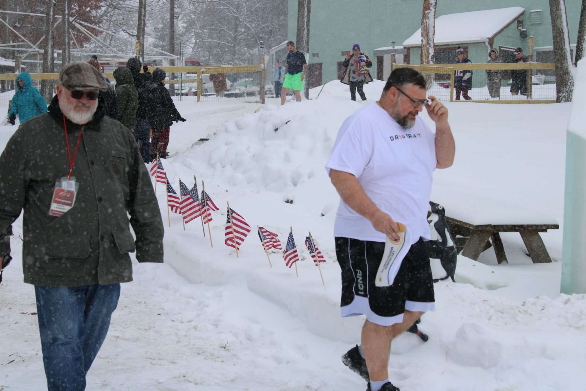 Robert Bruso, right, state commander for the AMVETS of Massachusetts, makes his way to theshore of Lake Cochituate for the annual Passion Plunge on Feb. 7.