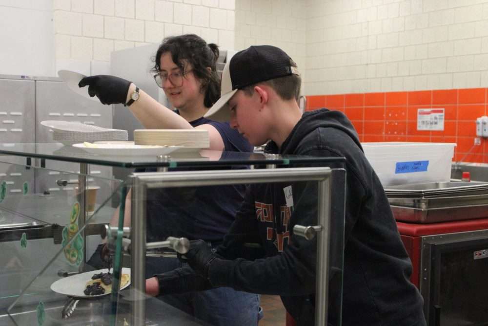 Volunteers serve up pancakes during the annual Maple Magic at Memorial School in SouthNatick.