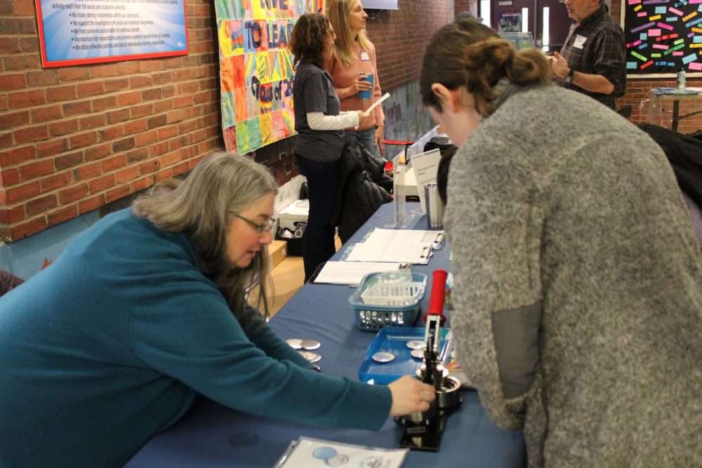 The Trustees of the Bacon Free Library featured a button-making station during the annualMaple Magic at Memorial School in South Natick on March 14.