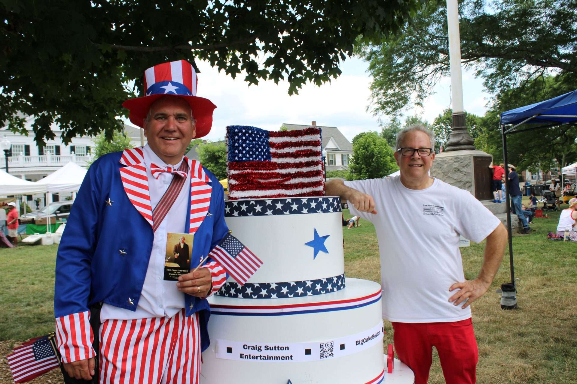 Uncle Sam, left, joins Craig Sutton at a special 250 th anniversary celebration prop cake duringthe Friends of the Fourth’s Picnic on July 4.