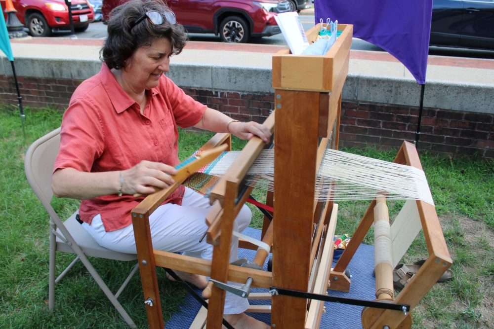 Weaving was one of the activities taking place on the Morse Institute Library lawn during Natick Nights on Aug. 6.
