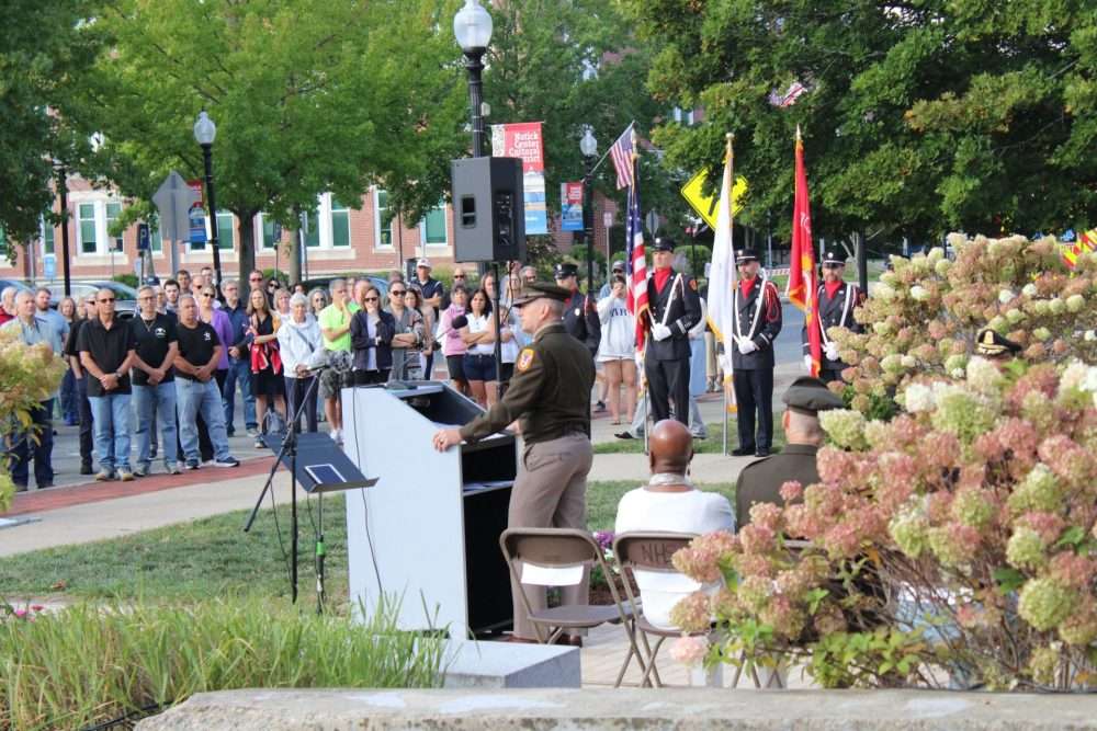 Brigadier General George Hackler, senior commander at the Soldier Systems Center, speaks during the town’s observances marking the 25 th anniversary of the terrorist attacks on Sept. 11, 2001.